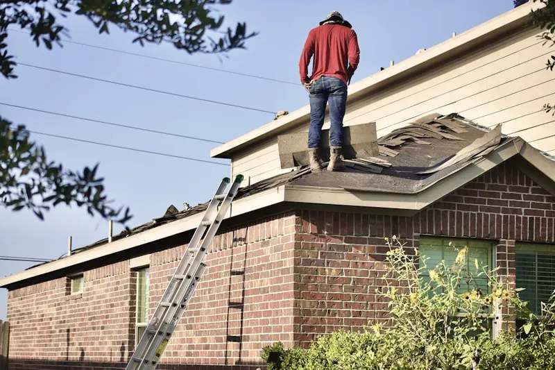Professional roofer working on a residential roof in Bryn Athyn
